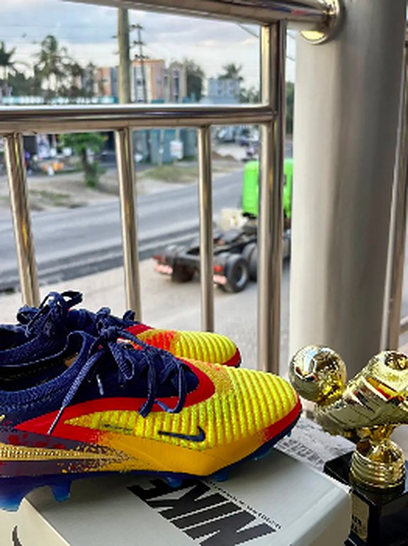 Navy, yellow and red football boots