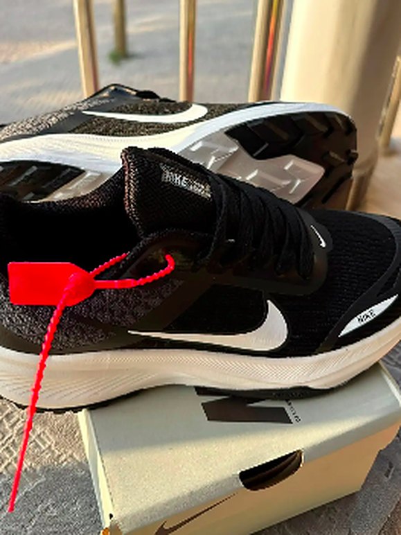 Black running shoes with red tag