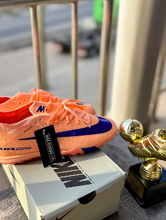 Orange and blue turf shoes